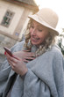 © liderina - Woman text messaging. Woman using smart phone outdoor.