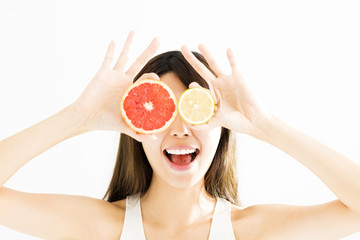 Wall Mural - happy Woman showing lemon with grapefruit.