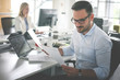 © liderina - Business people working. Business man reading document .