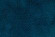 Background of dark blue suede fabric closeup. Velvet matt texture of navy blue nubuck textile