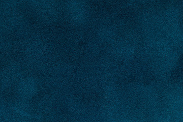 background of dark blue suede fabric closeup. velvet matt texture of navy blue nubuck textile