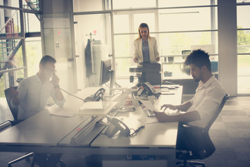 Wall Mural - Business people working in office. African man typing on laptop.