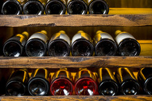 Wine Bottles On Wooden Shelves