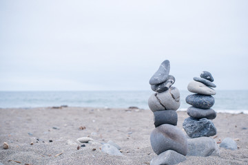 Monochrome, Serene, Blue Stacked rocks on a California beach symbolizing Peace, Balance, Meditation, and Mindfulness with Room for Copy