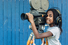 African American Girl Operating A Film Movie Camera