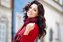 Beautiful Woman In A Red Autumn Sweater On The Street.