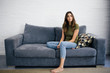 © Good Vibrations Images/Stocksy - Woman relaxing on the sofa at home
