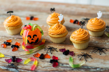 halloween party decorated cupcakes on wooden table