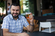 Happy man drinking beer in bar