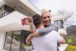 © .shock - couple hugging in front of  new luxury home