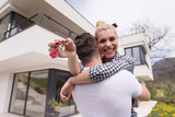Fototapeta  - couple hugging in front of  new luxury home