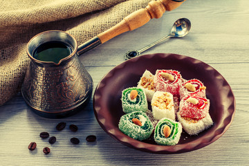 Turkish delight on clay plate with copper cezve