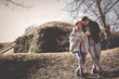 © liderina - Happy coupe walking trough park in hug. Cheerful couple in nature.
