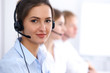 © rogerphoto - Call center. Focus on beautiful business  woman in headset