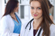 © rogerphoto - Young beautiful female doctor smiling to patient while consulting her