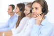 © rogerphoto - Call center operator in headset while consulting client. Telemarketing or phone sales. Customer service and business concept