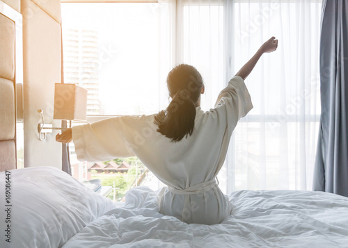 Cuadros en Lienzo Easy lifestyle young Asian girl waking up in the morning taking a rest relaxing