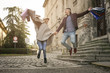 © liderina - Couple jumping after shopping. Couple holding shopping bags and jumping outdoor.