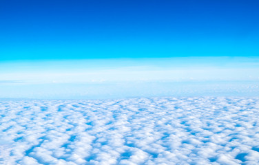 Wall Mural - blue sky and cloud top view from airplane window,nature background