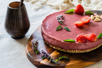 Raw healthy vegan cheesecake, homemade with cashew, mint and strawberries