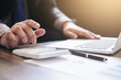 © Freedomz - Professional businessman working with calculator, Doing finance on laptop, document graph and analysis business strategy to development profit