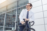 Fototapeta  - Senior business man with a bicycle outdoors