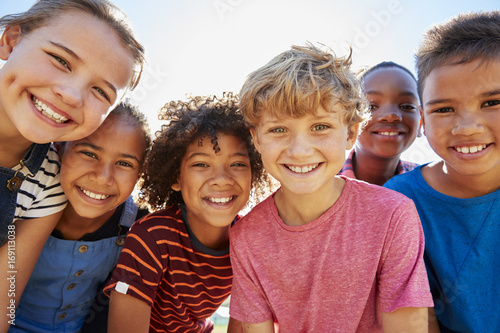Fotografie, Obraz Close up of pre-teen friends in a park smiling to camera