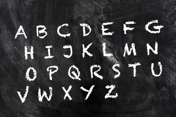 English alphabet by chalk on school blackboard