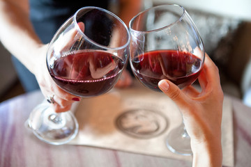 happy friends in a bar drinking red wine.