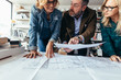 © Jacob Lund - Business people discussing over construction plan