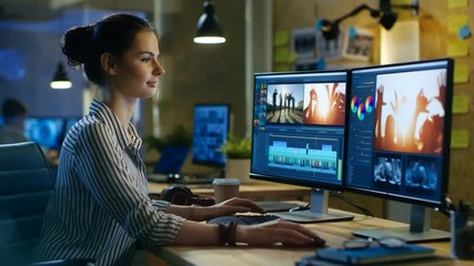 Wall Mural - beautiful female videographer edits footage on her personal computer, she works in creative office s