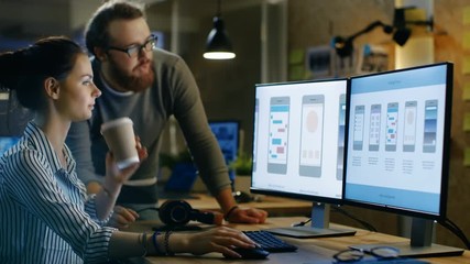 Female UX Architect Has Discussion with Male Design Engineer, They Work on Mobile Application Late at Night, She Drinks Coffee. 