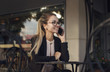 © xo4uphoto - Business woman or student talking on the phone and smiling