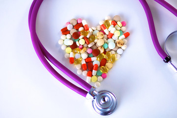 Canvas Print - Stethoscope and some pills - isolated on a white background