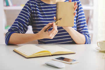 Wall Mural - Woman showing blank notepad