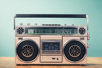 Wall Mural - retro outdated cassette tape recorder from 80s on table front mint green background. vintage old sty