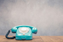 Retro Old Mint Green Telephone From 60s On Table Front Textured Concrete Wall Background. Vintage Style Filtered Photo