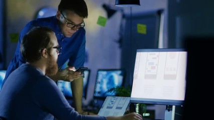 Two Male Mobile Application Developers Design and Create Quality Product. It's Late at Night They' the Only Ones Who are in the Office. Shot on RED EPIC-W 8K Helium Cinema Camera.