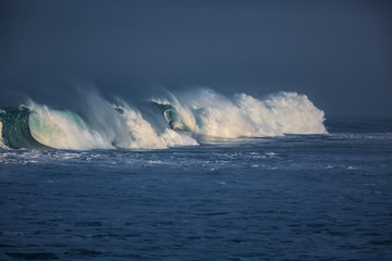 Wall Mural - surfer riding ocean waves at sunrise