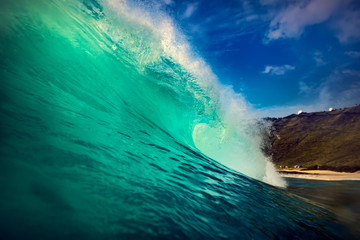 Wall Mural - big ocean green wave. water surface in barrel surfing shape.