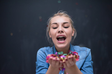 Wall Mural - woman blowing confetti in the air