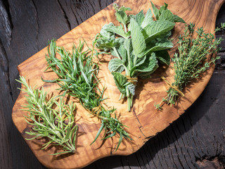 Wall Mural - Fresh herbs on the wooden table.