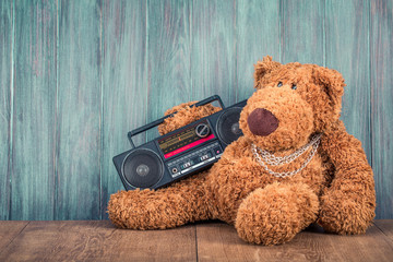 Wall Mural - retro teddy bear toy and old outdated ghetto blaster radio recorder from 80s front grunge wooden wal