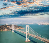 Fototapeta  - Aerial view of Bay Bridge in  San Francisco from helicopter, CA