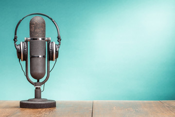 Poster - Retro big ribbon microphone and headphones on table front gradient aquamarine background. Vintage old style filtered photo