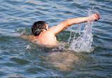 Fototapeta Łazienka - The man is swimming in the lake