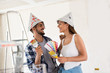 © didesign - Funny couple choosing colors for painting their new house
