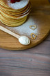 © Роксолана Осыка - Tasty homemade pancakes with cream and raspberry. On wooden table. Village kitchen