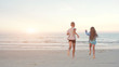 © zulman - Children friends boy and girl running into the sea