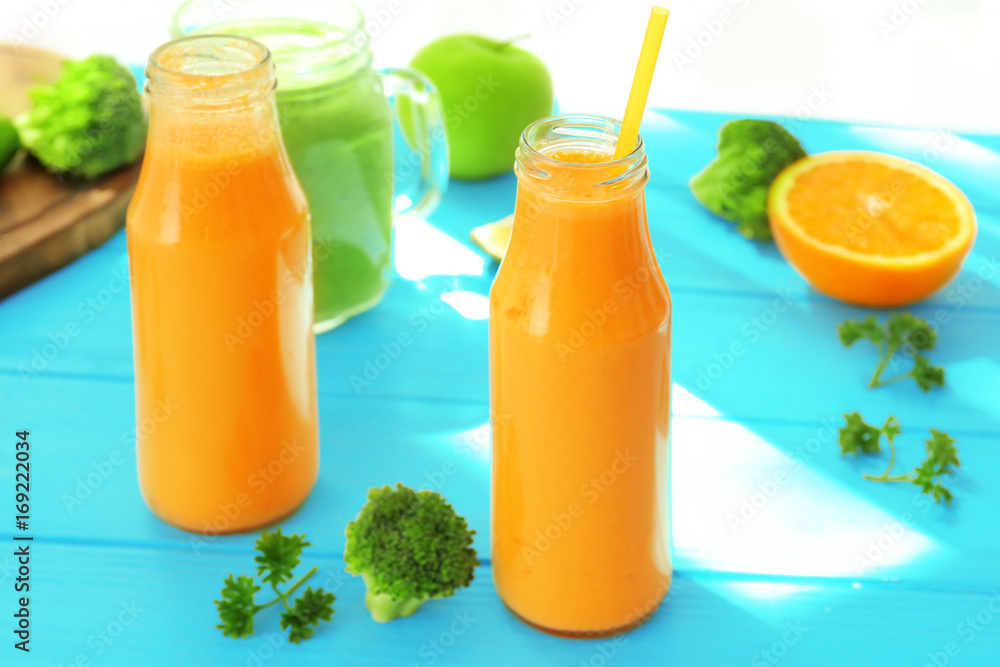 Fresh smoothies with fruits and vegetables on table
